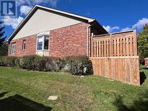 London North (North A) townhouse for rent - A house with a red brick exterior and a wooden fence.