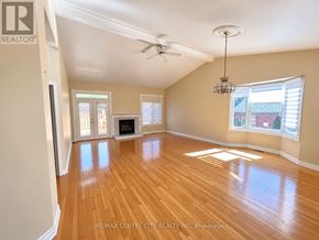 London North (North A) townhouse for rent - A spacious room with wooden floors and a ceiling fan.