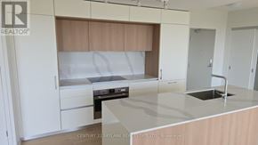 Toronto (Annex) condo for rent - A kitchen with white cabinets and a wooden backsplash.