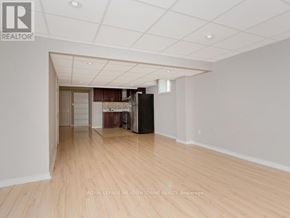 Milton (Co Coates) apartment for rent - A spacious room with wooden flooring and white walls.