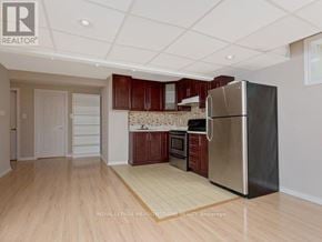 Milton (Co Coates) apartment for rent - A kitchen with wooden floors and a refrigerator.