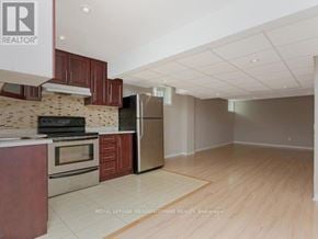 Milton (Co Coates) apartment for rent - A kitchen with a refrigerator, oven, and stove.