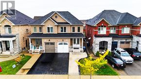Brampton (Bram East) apartment for rent - A house with a driveway and a garage is shown in the image.