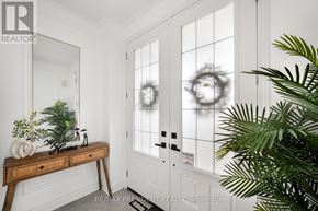 Brampton (Bram East) apartment for rent - A white room with a wooden desk and a plant.