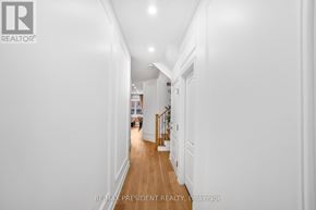Brampton (Bram East) apartment for rent - A long hallway with white walls and wood floors.