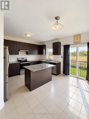 Southgate apartment for rent - A kitchen with a refrigerator, sink, and stove top.