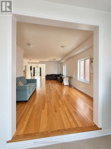 Southgate apartment for rent - A living room with a blue couch and wooden floors.