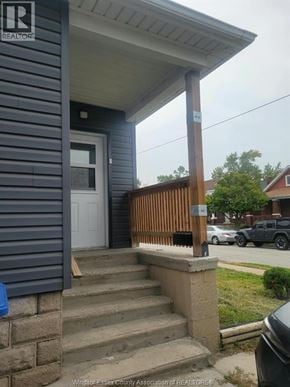 Windsor apartment for rent - A house with a porch and a sign that says REALTOR.