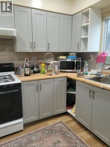 Windsor apartment for rent - A kitchen with a black stove top oven and white cabinets.
