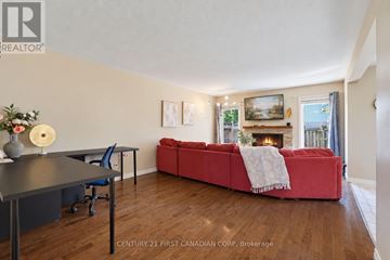 London North (North I) apartment for rent - A living room with a red couch and a fireplace.