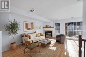 Ottawa townhouse for rent - A living room with a couch, chair, and a potted plant.