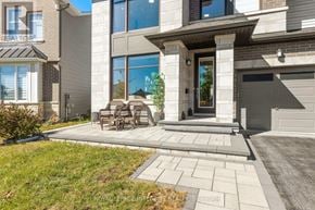 Ottawa apartment for rent - A modern house with a large front yard and patio furniture.