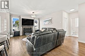 Ottawa apartment for rent - A living room with a grey sofa and a television.