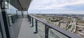 Toronto (Waterfront Communities) condo for rent - A balcony with glass railings overlooks a construction site.