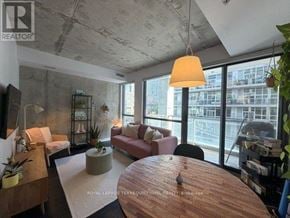 Toronto (Waterfront Communities) condo for rent - A living room with a couch, chairs, and a table.