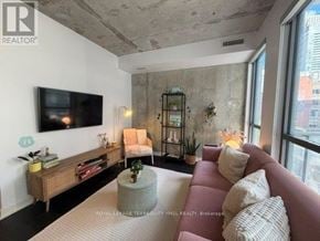 Toronto (Waterfront Communities) condo for rent - A living room with a flat screen TV mounted on the wall.