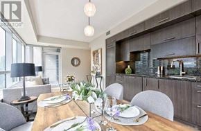 Toronto (Willowdale East) condo for rent - A modern dining room with a wooden table set for a meal.