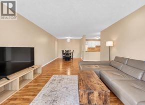 Maple Ridge apartment for rent - A living room with a wooden floor and a grey couch.