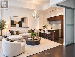 Toronto (Church-Yonge Corridor) condo for rent - A modern living room with a white sofa, a coffee table, and a chandelier.