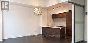Toronto (Church-Yonge Corridor) condo for rent - A modern kitchen with a wooden island and a chandelier hanging from the ceiling.
