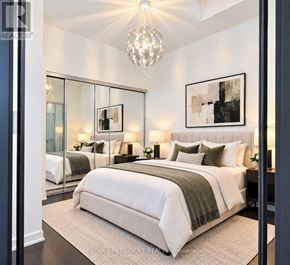 Toronto (Church-Yonge Corridor) condo for rent - A bedroom with a large bed and a chandelier.