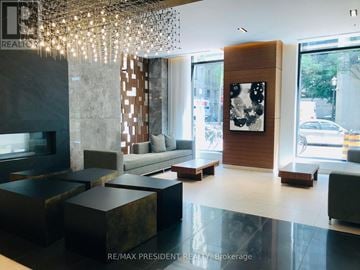 Toronto (Church-Yonge Corridor) condo for rent - A modern living room with a fireplace and a large painting on the wall.