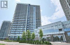 Mississauga (Central Erin Mills) condo for rent - A tall building with a glass facade is in the foreground with a REALTOR sign in the corner.