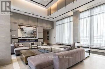 Mississauga (Central Erin Mills) condo for rent - A living room with a large painting on the wall and a coffee table in the center.