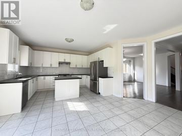 Newmarket (Woodland Hill) apartment for rent - A spacious kitchen with white cabinets and black countertops.