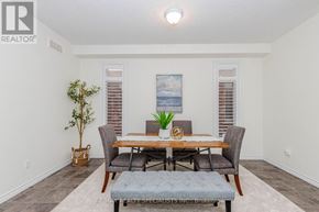 Guelph (Victoria North) apartment for rent - A dining room with a wooden table and grey chairs.