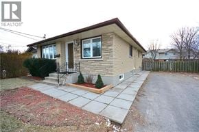 St. Catharines apartment for rent - A house with a brown roof and a small front yard.