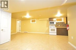 St. Catharines apartment for rent - A spacious room with a kitchenette and a fire extinguisher.