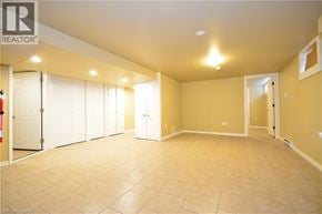 St. Catharines apartment for rent - A spacious room with tile flooring and a ceiling light fixture.