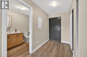 South Dundas condo for rent - A bathroom with a toilet, sink, and a large closet door.