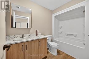 South Dundas condo for rent - A bathroom with a marble countertop and a walk-in shower.