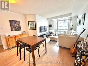 Toronto (Waterfront Communities) condo for rent - A living room with a wooden dining table and chairs, a couch, and a guitar on the floor.
