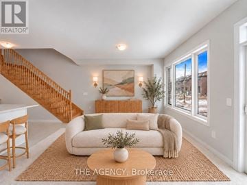 Kawartha Lakes (Lindsay) townhouse for rent - A living room with a couch, a table, and a painting on the wall.