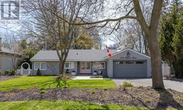 Burlington (Roseland) apartment for rent - A house with a grey roof and a white fence is shown.