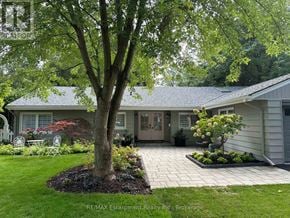 Burlington (Roseland) apartment for rent - A tree in a yard in front of a house.