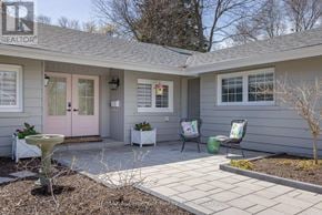 Burlington (Roseland) apartment for rent - A grey house with a pink door and a white table and chairs on the patio.