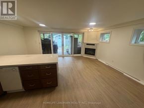 Toronto (Lansing-Westgate) apartment for rent - A spacious room with wooden flooring and a washing machine in the corner.