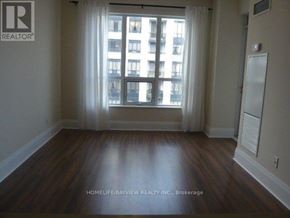 Toronto (Willowdale East) condo for rent - A room with wooden floors and a window with white curtains.