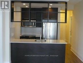 Toronto (Willowdale East) condo for rent - A modern kitchen with a sink and a stove top oven.