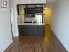 Toronto (Willowdale East) condo for rent - A kitchen with a sink and cabinets in a room with wooden floors.