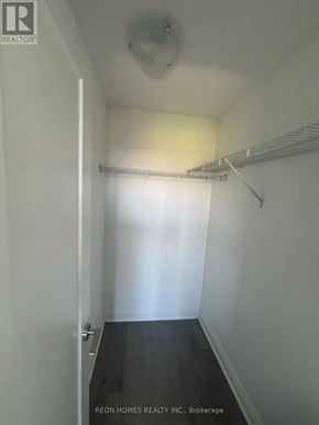 Toronto (Tam O'shanter-Sullivan) condo for rent - A white hallway with a door on the left and a shelf on the right.
