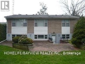 Richmond Hill (South Richvale) apartment for rent - A two-story brick house with a garage and a small garden in front.