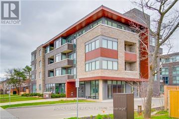 Burlington (Mountainside) condo for rent - A modern multi-story building with a red roof and brick exterior.