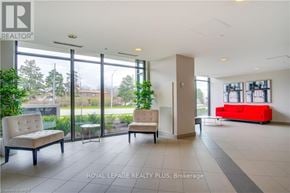 Burlington (Mountainside) condo for rent - A spacious waiting area with a red couch and two chairs.