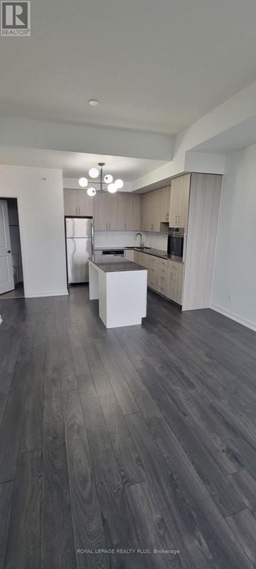 Burlington (Mountainside) condo for rent - A modern kitchen with wooden floors and white cabinets.