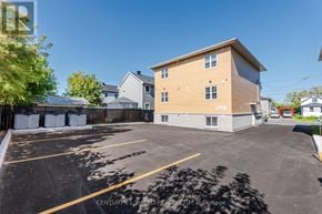 Cornwall triplex for rent - A parking lot with a building in the background.